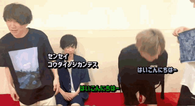 a man in a black t-shirt is kneeling down next to another man in a white shirt