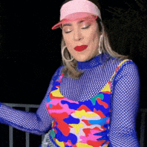 a woman wearing a pink hat and a colorful outfit
