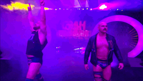 a couple of men standing in front of a sign that says goak