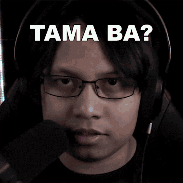 a man wearing glasses and headphones with the words tama ba on his face