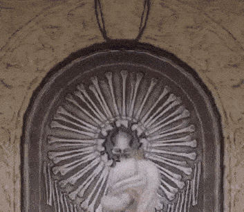 a girl with a crown on her head is standing in front of a skeleton statue .