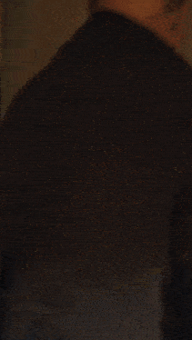 a man with glasses and a beard looks at the camera