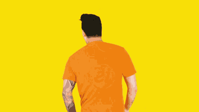 a man wearing an orange t-shirt with the letter ei on it