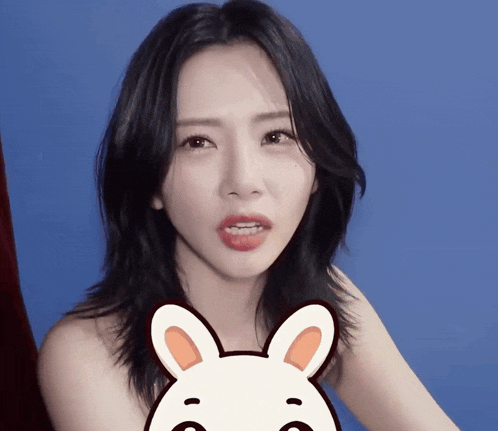 a woman without a shirt has a cartoon bunny on her face