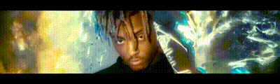 a man with dreadlocks is standing in front of a wall with a glowing light behind him .