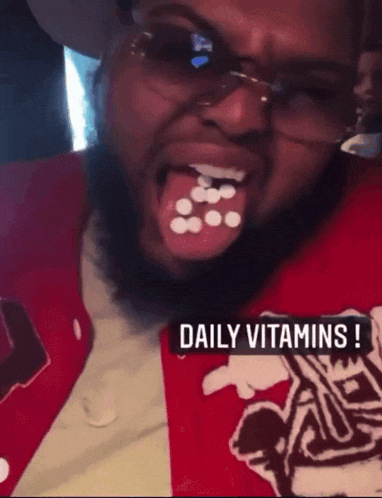 a man with pills on his tongue and the words daily vitamins