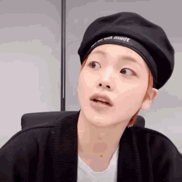 a person wearing a black hat that says youth