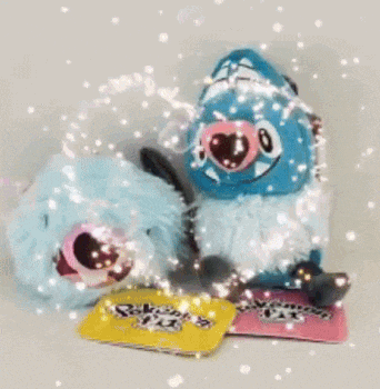 a couple of stuffed animals sitting next to each other on a table
