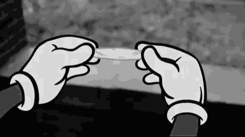 a cartoon hand is holding a piece of paper