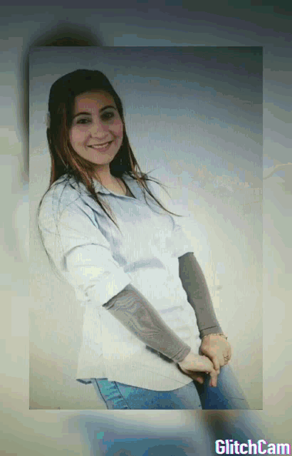 a woman in a white shirt is smiling in a glitchcam image
