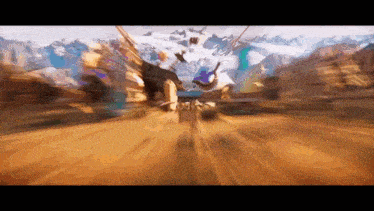 a blurry picture of a person riding a bike in a desert with mountains in the background
