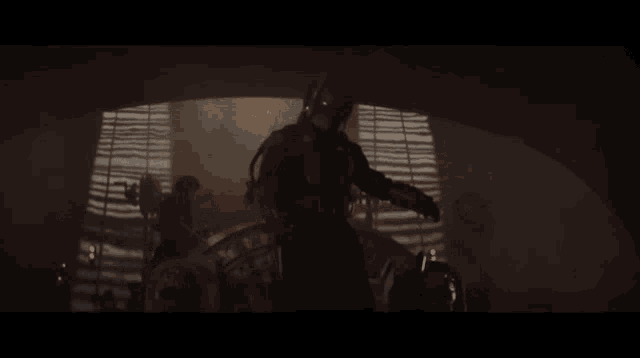 boba fett is sitting in a dark room with a window