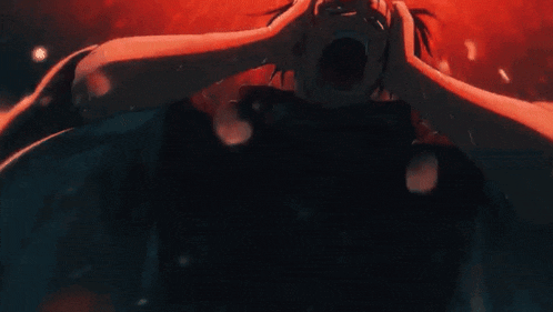 a close up of a person holding their head in a dark room