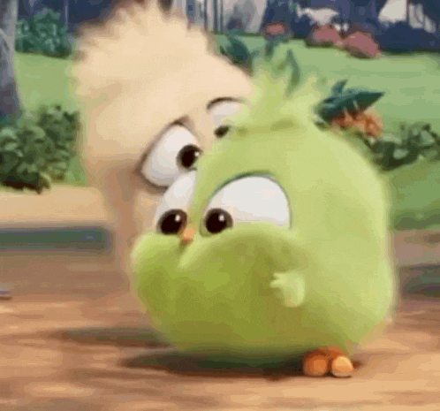 a close up of a green angry bird from the angry birds movie standing next to a squirrel .