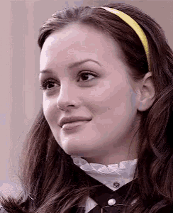 a close up of a woman 's face with a yellow headband on