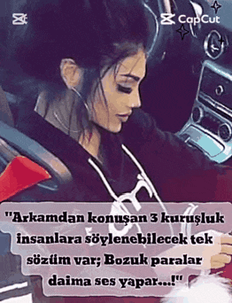 a woman is sitting in the driver 's seat of a car with a caption in a foreign language .