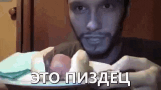 a man is holding a plate of food in his hands .
