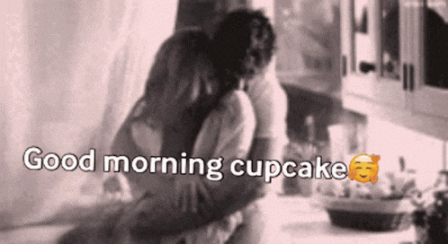 a black and white photo of a man and woman hugging with the words good morning cupcake above them