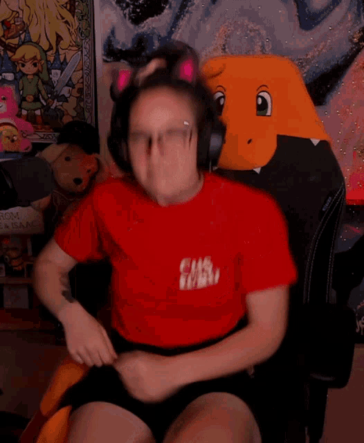 a woman wearing headphones and a red shirt that says chs 101 on it