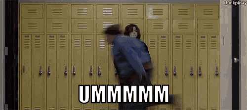 a man and a woman are standing in front of a row of lockers with the words ummmmm written on the bottom