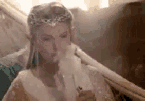 a woman in a white dress is smoking a cigarette while wearing a crown .