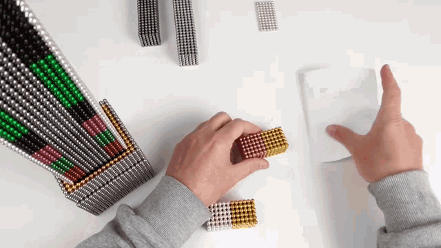 a person is playing with a bunch of magnets