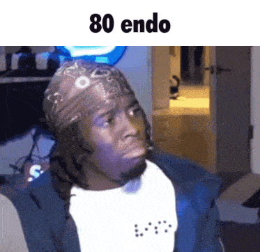 a man wearing a bandana and a bib with the words 80 endo above him
