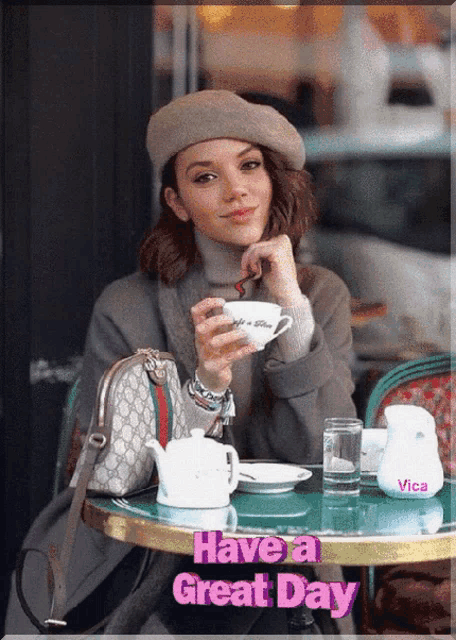 a woman is sitting at a table with a cup of coffee and the words have a great day on the bottom