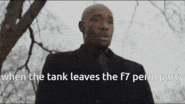 a man in a suit and tie is standing in front of a tree with the words when the tank leaves the f7 perm party
