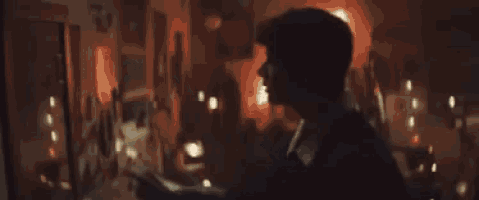 a man wearing a pair of glasses is looking at another man .