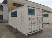 a white shipping container is parked in front of a building