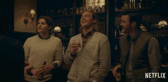 a netflix ad features three men laughing and drinking beer