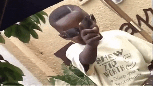 a young boy wearing a shirt that says show zip worth keep your determination