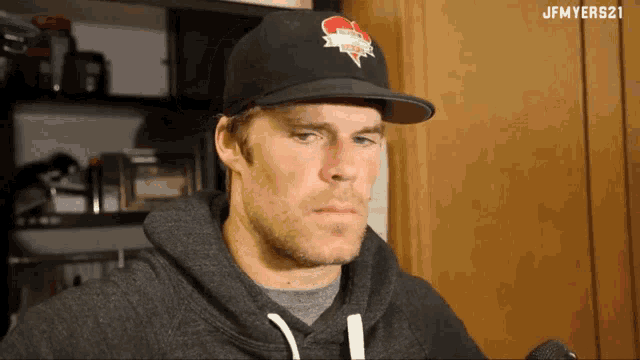 a man wearing a hat with a heart on it