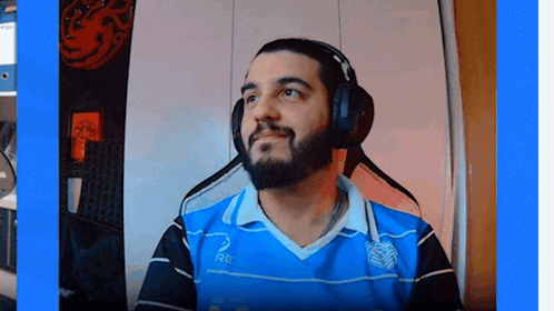a man wearing headphones and a blue shirt with the number 2 on the front