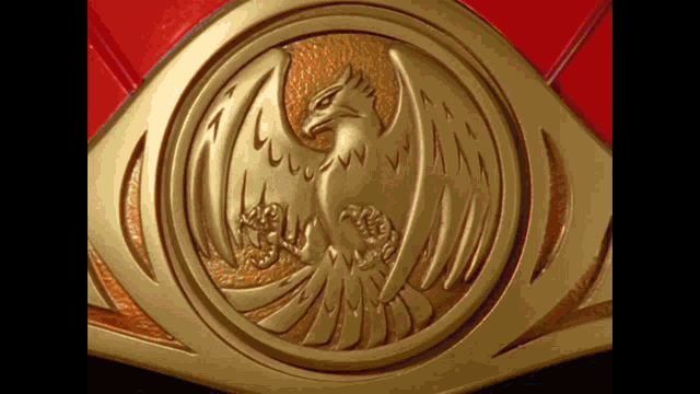 a gold emblem with a bird on it