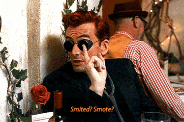 a man with red hair and sunglasses says " smited "
