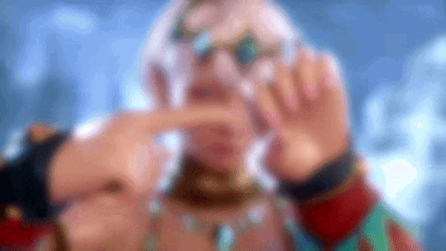 a blurry picture of a man wearing glasses and a necklace .