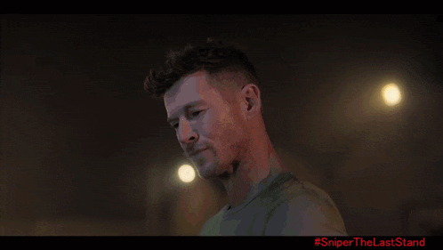 a man is standing in a dark room with smoke coming out of the ceiling .