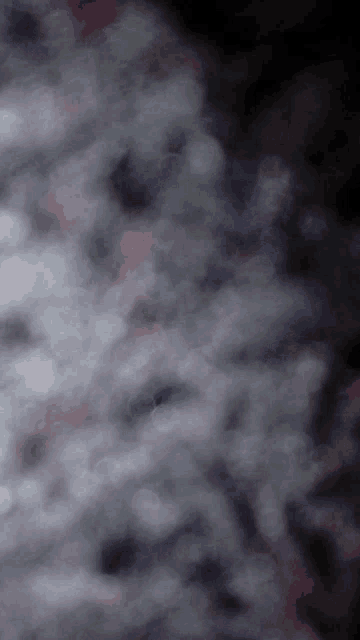 a dark background with a lot of clouds in it