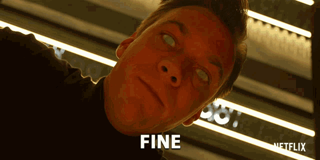 a close up of a man 's face with the word fine written on it