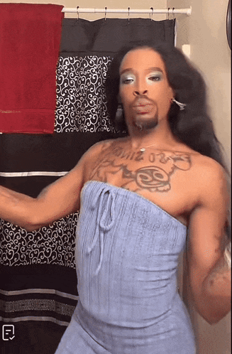 a man in a blue dress has a tattoo on his chest that says ss