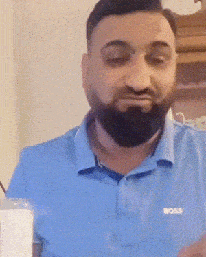 a man with a beard is wearing a blue shirt that says boss
