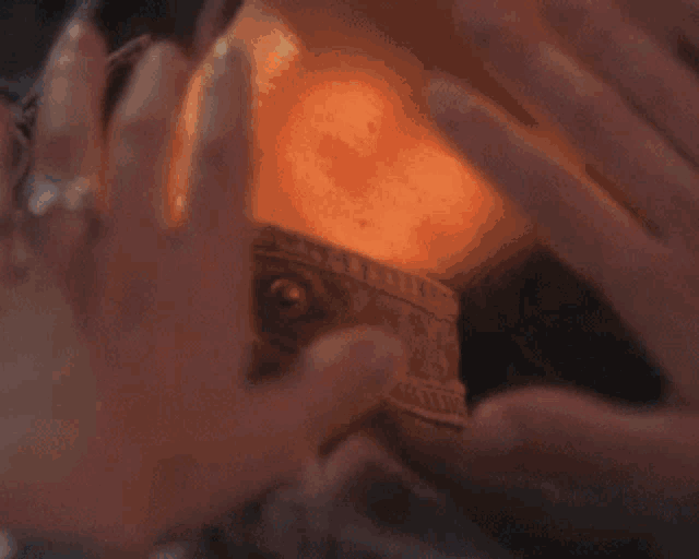 a close up of a person 's hand holding a piece of paper that says ' a ' on it