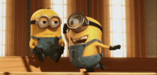 two minions wearing goggles and overalls are sitting next to each other