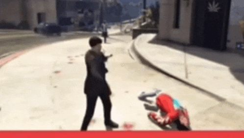 a man in a suit is standing on a sidewalk next to a person laying on the ground ..