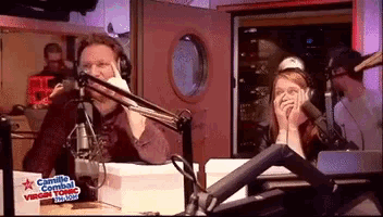 a man and a woman in front of a microphone with a sign that says camille combat virgin tonic on it
