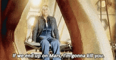 a woman is sitting on a chair and says if we end up on mars i 'm gonna kill you