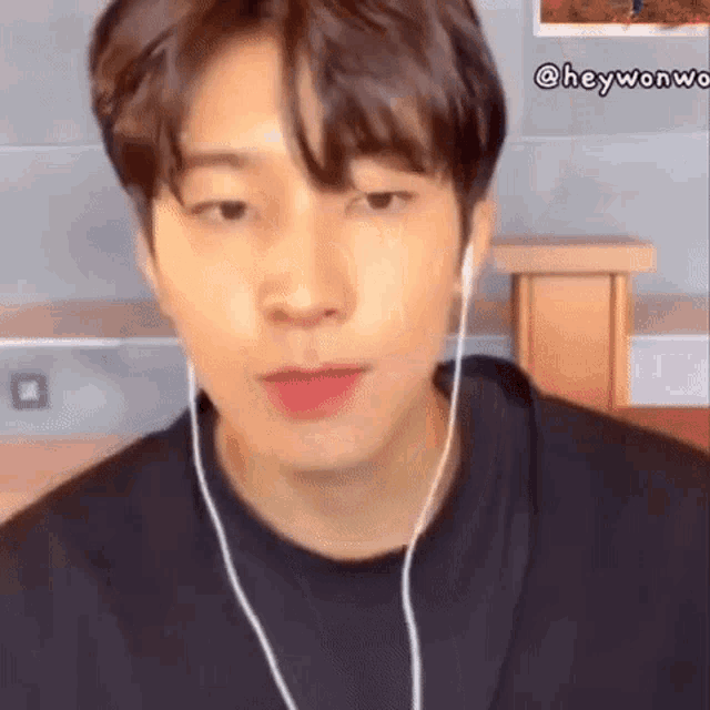 a close up of a person wearing headphones and a black shirt .