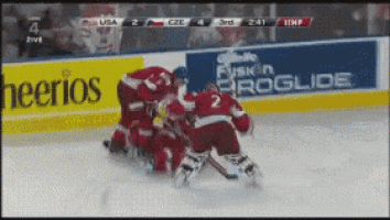 a hockey game is being played in front of a cheerios banner